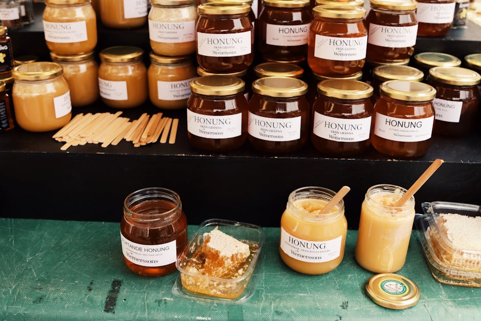 Jars of Swedish honey displayed at a market in Jönköping, Sweden, showcasing a variety of flavors.
