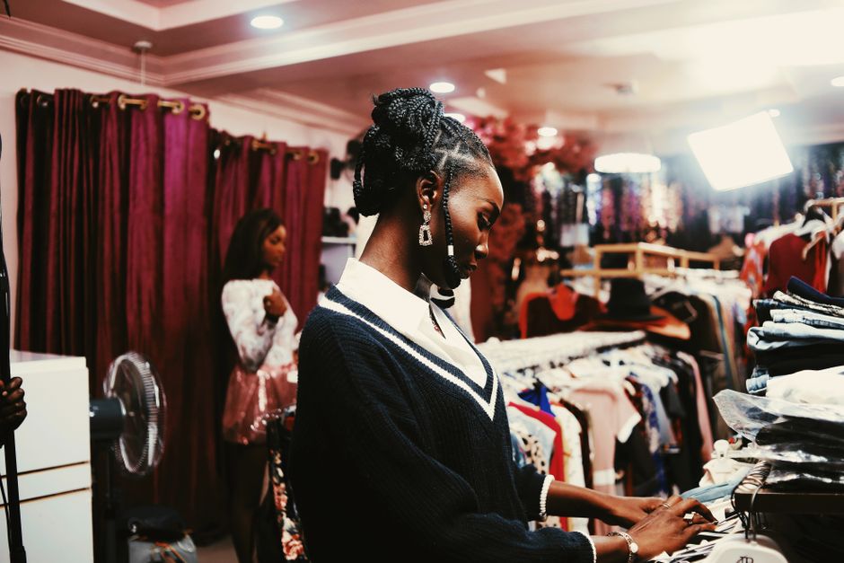 Two women shopping in stylish Abuja boutique. Fashion, elegance and modern trends.